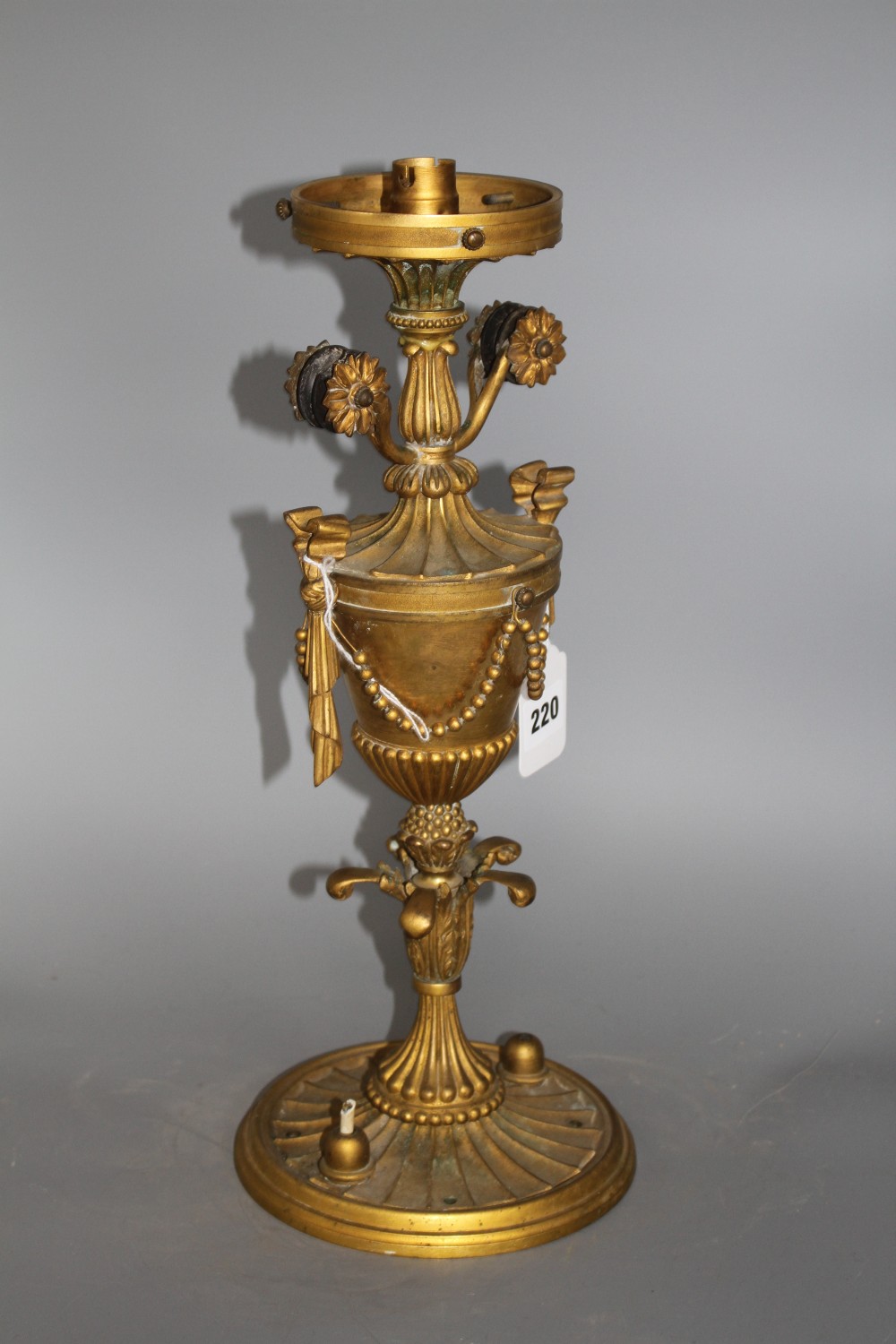 An early 20th century ormolu light fitting, lacking glass shade, height 41cm